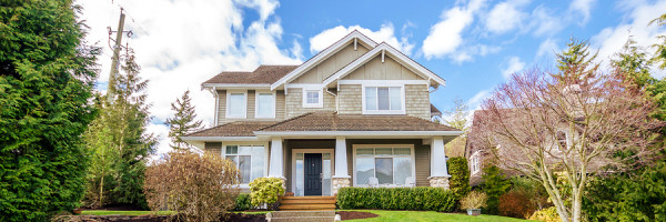 Luxury house with beautiful landscaping on a sunny day. Home exterior design. Luxury house with beautiful landscaping on a sunny day. Home exterior design.